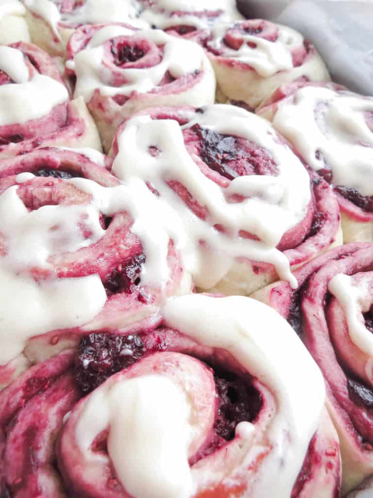 Mixed Berry Sweet Rolls With Vanilla Cream Cheese Glaze finished after baking and spreading on glaze.