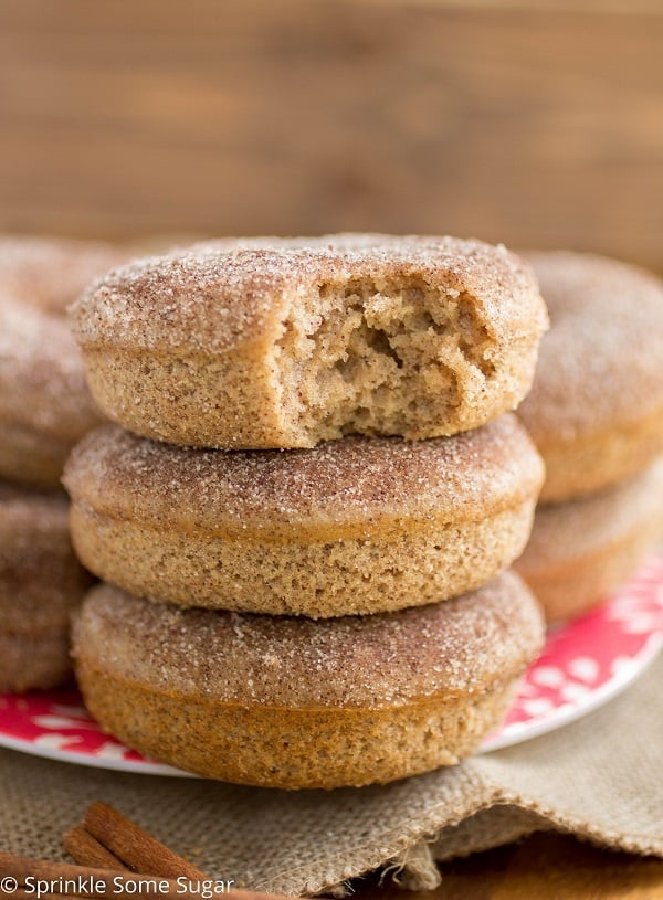 Stack of Cinnamon Sugar Donuts with a bite taken out of the top one.
