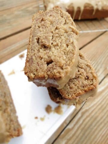 Banana bread slices staked on a plate.