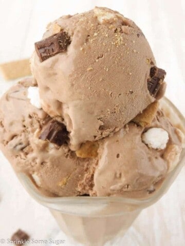Creamy toasted smores chocolate ice cream scooped into a glass cup.