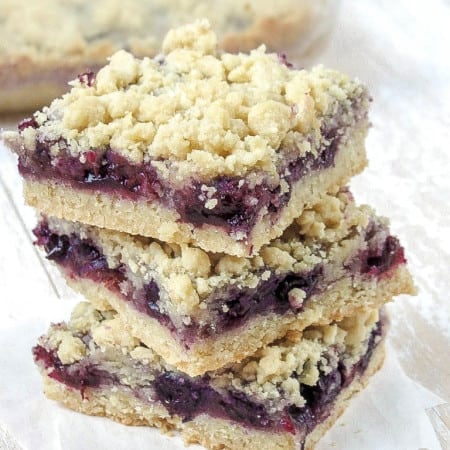 Blueberry crumble bars stacked.
