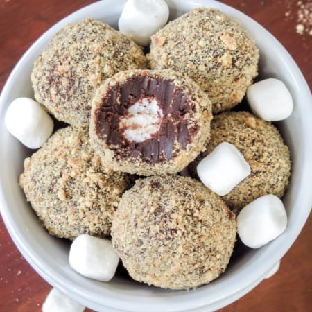 S'mores truffles in a bowl revealing the inside.