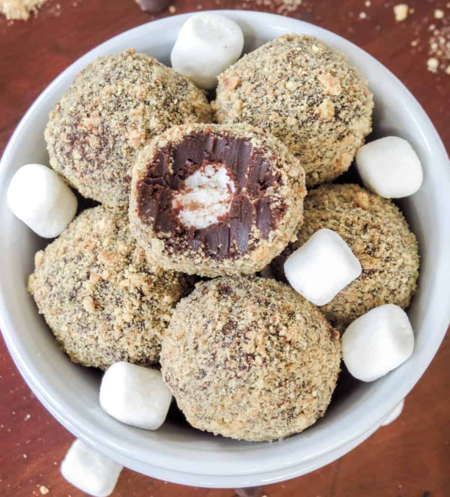 S'mores truffles in a bowl revealing the inside.