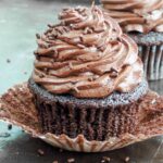 Chocolate cupcake with paper liner unwrapped.