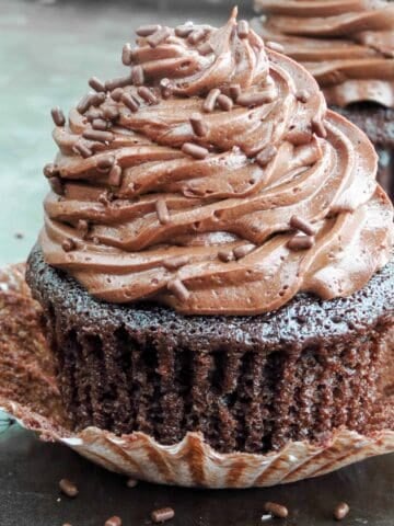 Chocolate cupcake with paper liner unwrapped.