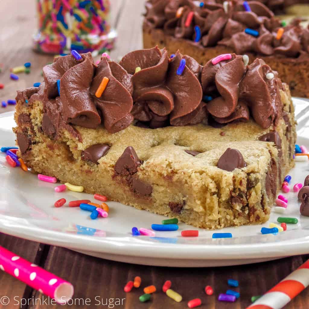 Slice of chocolate chip cookie cake on a plate.