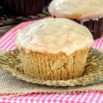 Apple cider muffin with glaze and wrapping unwrapped.
