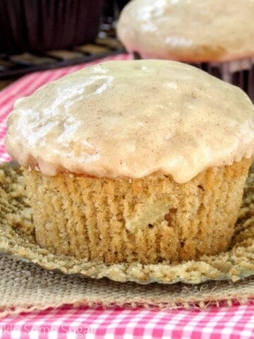 Apple cider muffin with glaze and wrapping unwrapped.