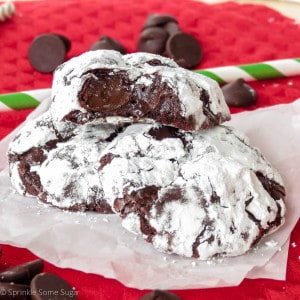 Good chocolate truffle cookies stacked on top of eachother with the top cookie revealing the gooey center.