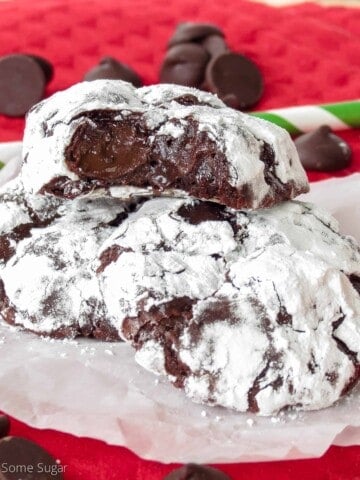 Good chocolate truffle cookies stacked on top of eachother with the top cookie revealing the gooey center.
