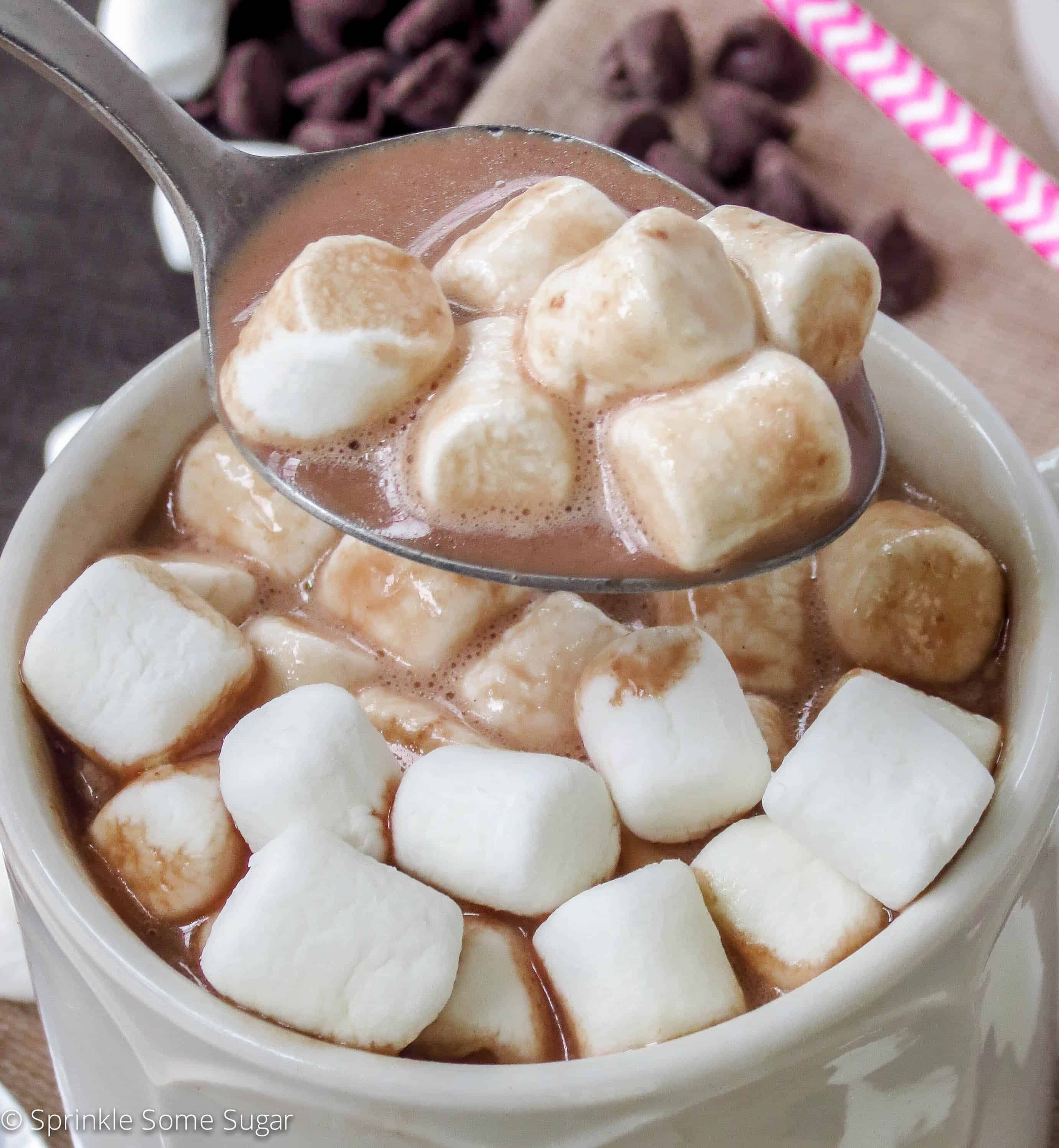 Homemade hot chocolate in a mug with a spoon.