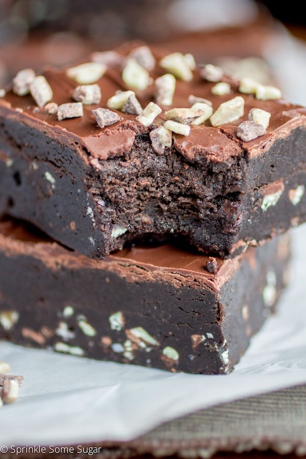 Mint Overload Truffle Brownies stacked with a bite taken out.