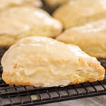 Fresh Orange Scones with glaze on top on a cooling rack.