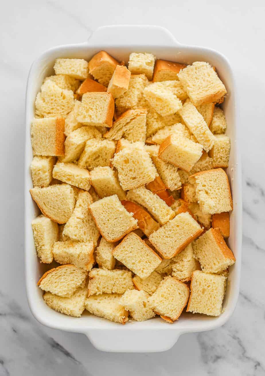 Pieces of bread in a pan for overnight French toast casserole.