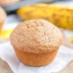 Banana muffin on a piece of parchment paper.