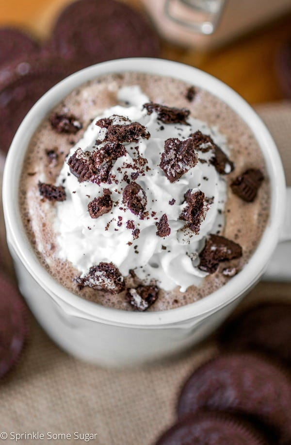 Oreo hot chocolate in a mug with whipped cream and crushed Oreos.