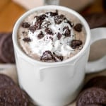 Mug of oreo hot chocolate with oreos around it.