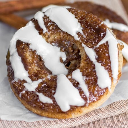 Cinnamon roll donut on parchment paper.