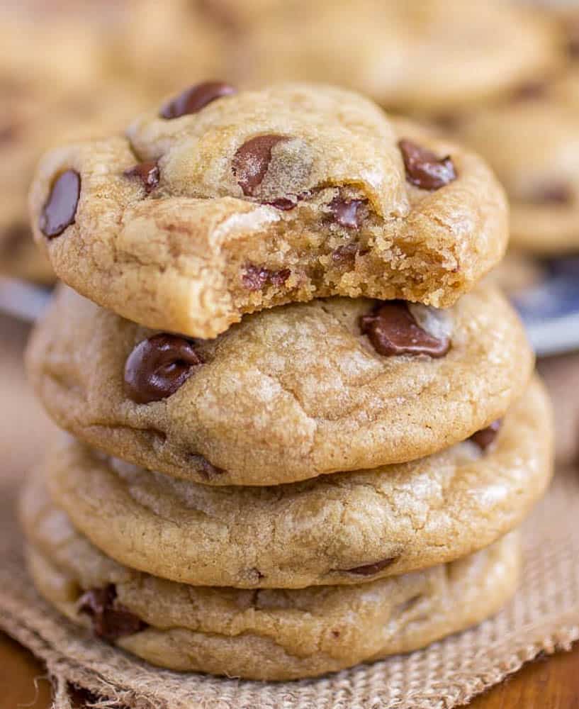 Stack of chocolate chip cookies with the top one bitten.