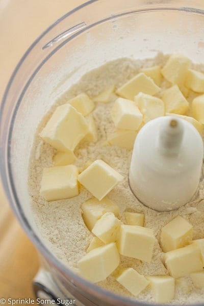 Cutting butter into flour mixture for pie crust.