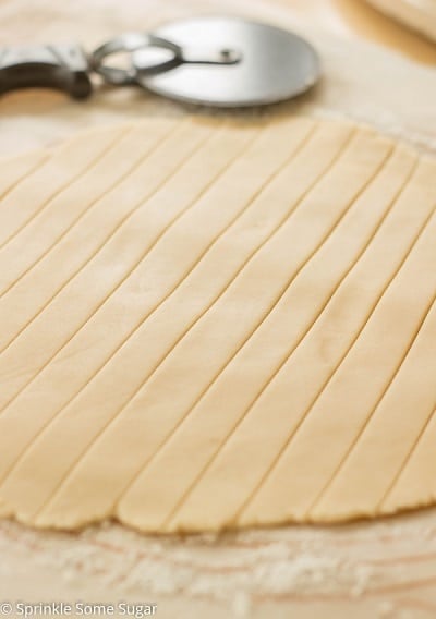 Pie crust rolled out and cut into long strips.