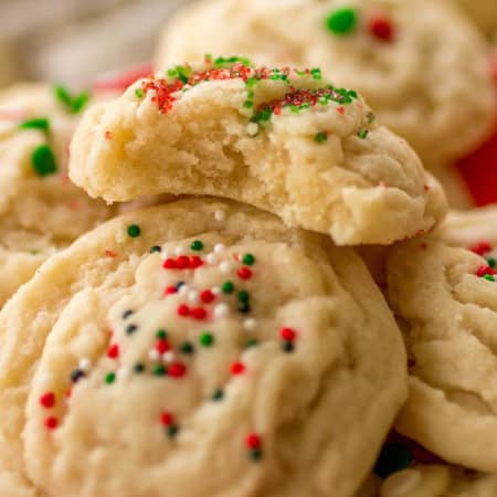 Soft amish sugar cookies stacked with the top cookie bite taken out.