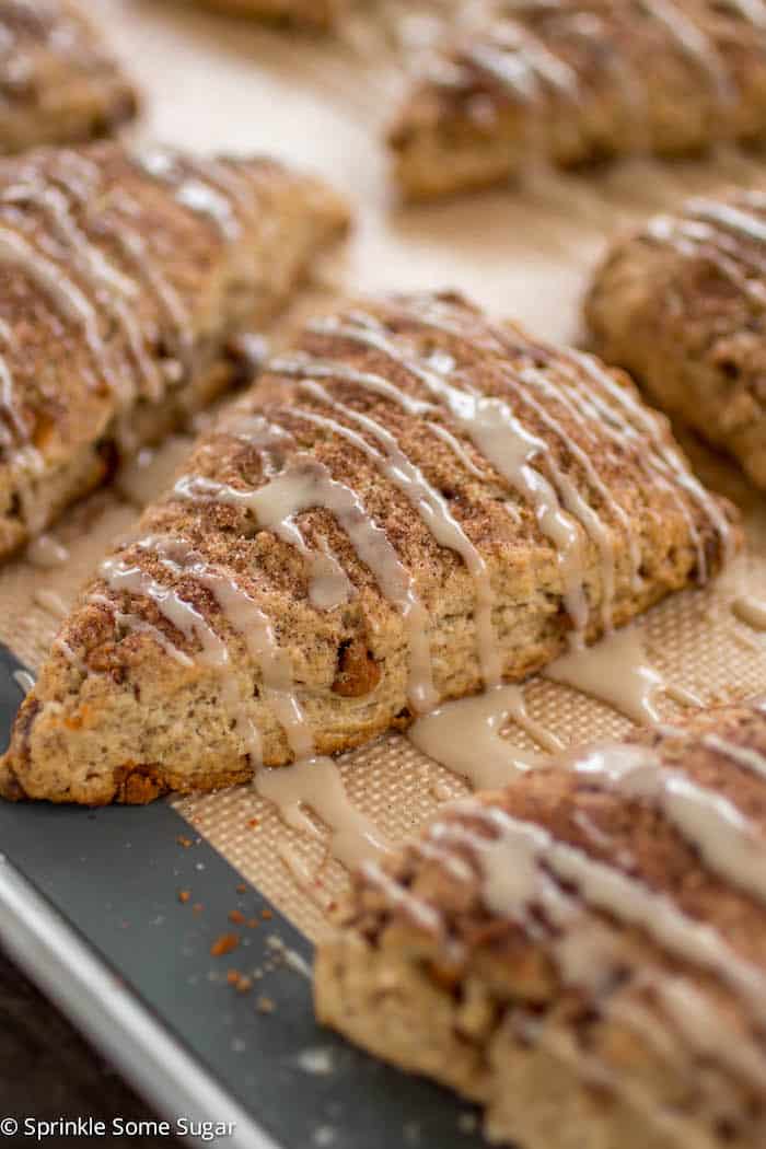 Cinnamon roll scones on a baking mat.