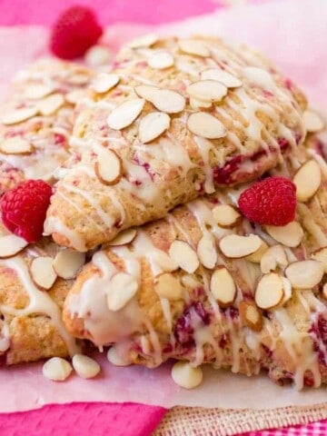 White Chocolate Raspberry Almond Scones stacked on top of each other.