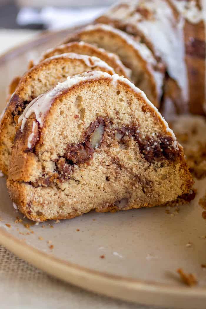 Pecan Cinnamon Roll Bundt Cake - This cake is so soft with a gooey cinnamon swirl in the center! All of the flavors you love about a cinnamon roll, in a super easy cake!