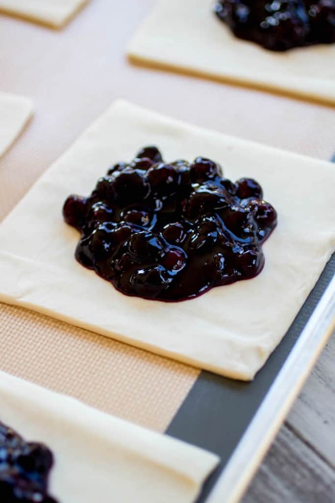Blueberry Turnovers - Flakey pastry dough is filled with gooey homemade blueberry filling.