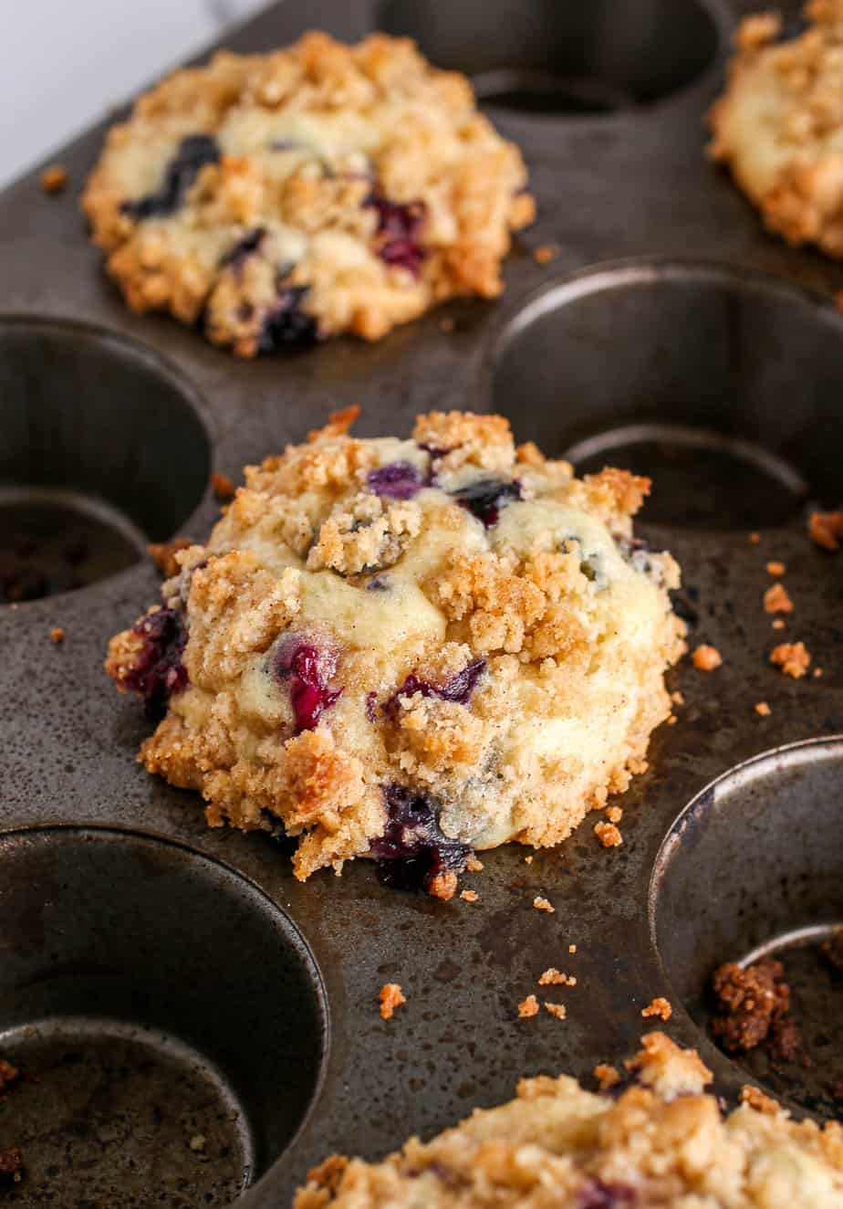Blueberry Muffins With Crumb Topping baked in muffin pan.