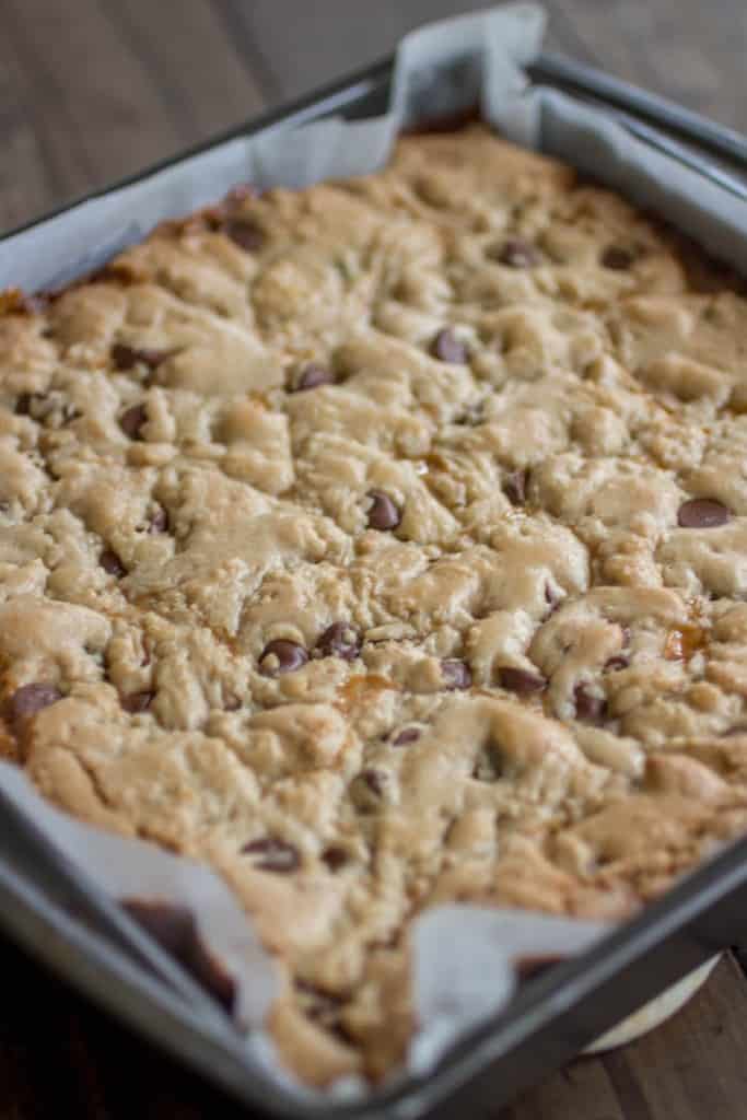 Baked salted caramel chocolate chip cookie bars before slicing in the pan.