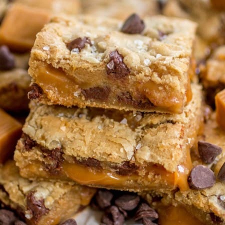 Salted caramel chocolate chip cookie bars stacked on top of one another.