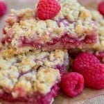 Raspberry lemon crumble bars stacked on top of eachother.