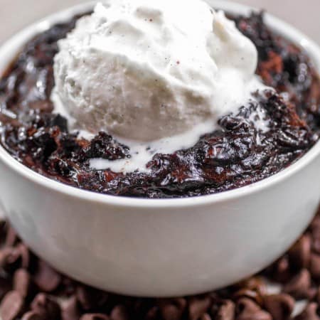Slow Cooker Brownie Pudding in a bowl with vanilla ice cream on top.