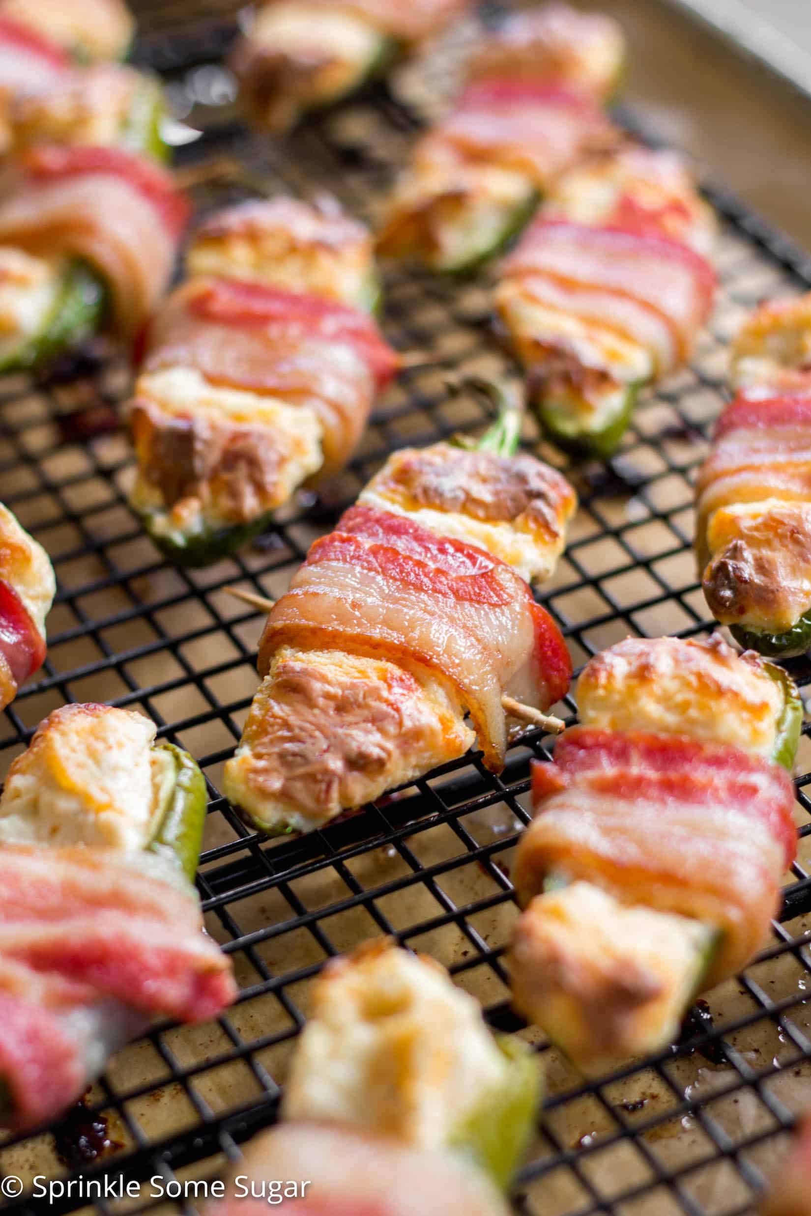 Bacon-Wrapped Jalapeño Poppers - Creamy, cheesy filled jalapeños are wrapped in a layer of juicy, crispy bacon. Talk about mouth-watering!