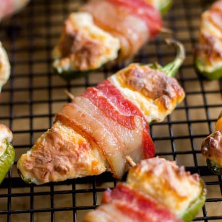 Bacon-Wrapped Jalapeño Poppers - Creamy, cheesy filled jalapeños are wrapped in a layer of juicy, crispy bacon. Talk about mouth-watering!