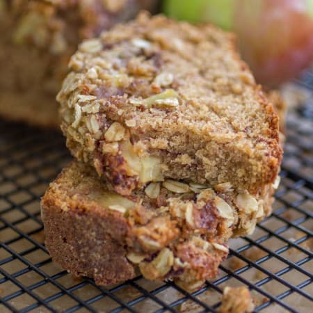 Apple Cinnamon Streusel Bread slices stacked on top of each other with the top one missing a bite.