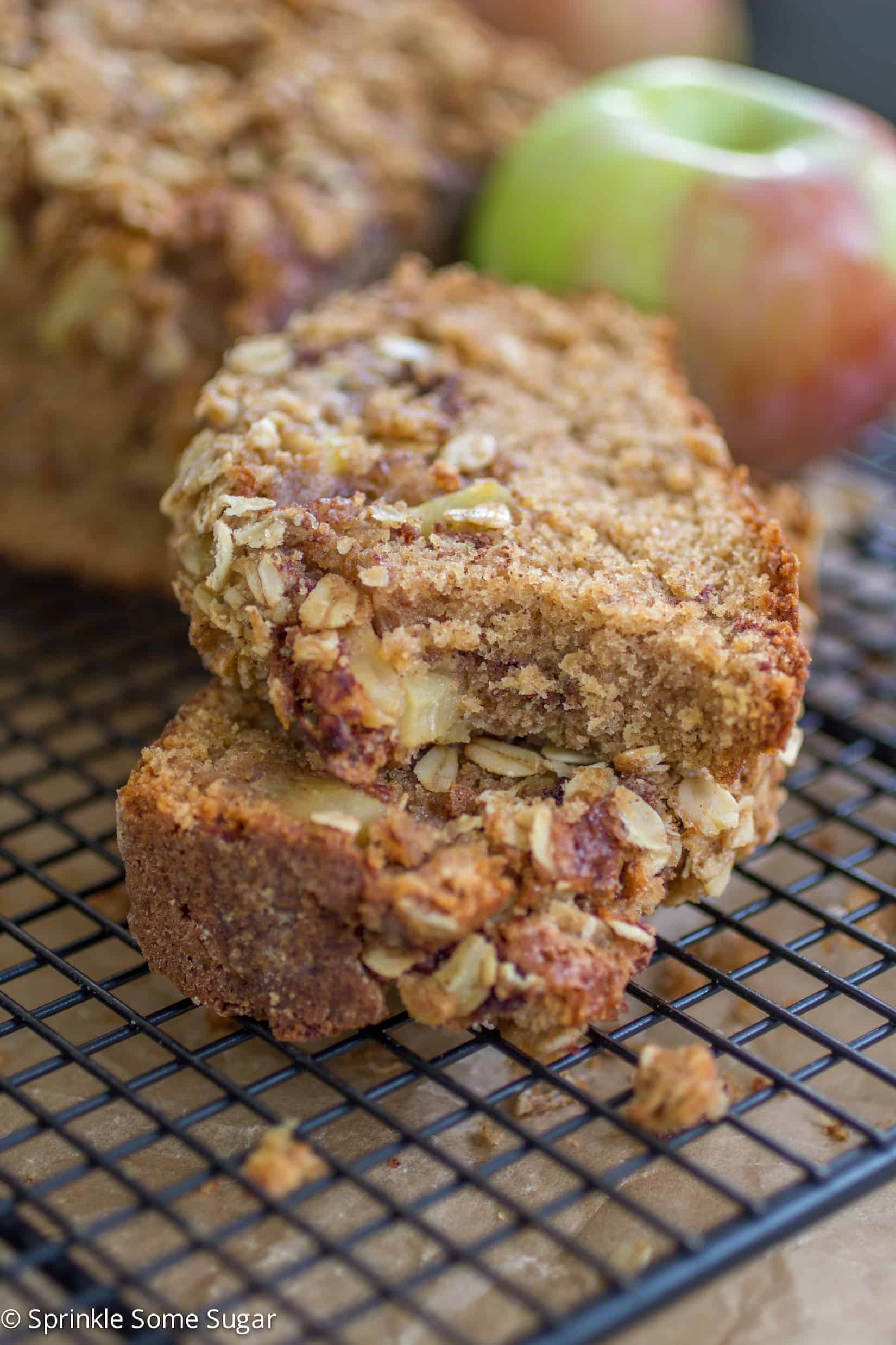 Apple Cinnamon Streusel Bread slices stacked on top of each other with a bite taken out of the top slice.