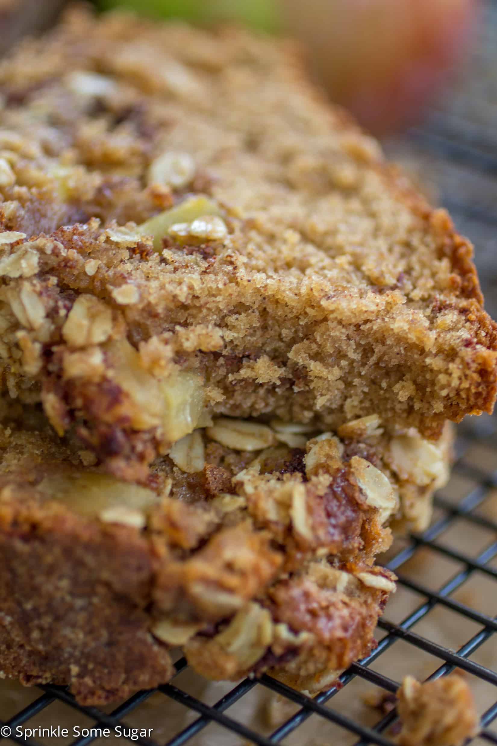 Apple Cinnamon Streusel Bread slices stacked on top of each other with a bite taken out of the top slice.