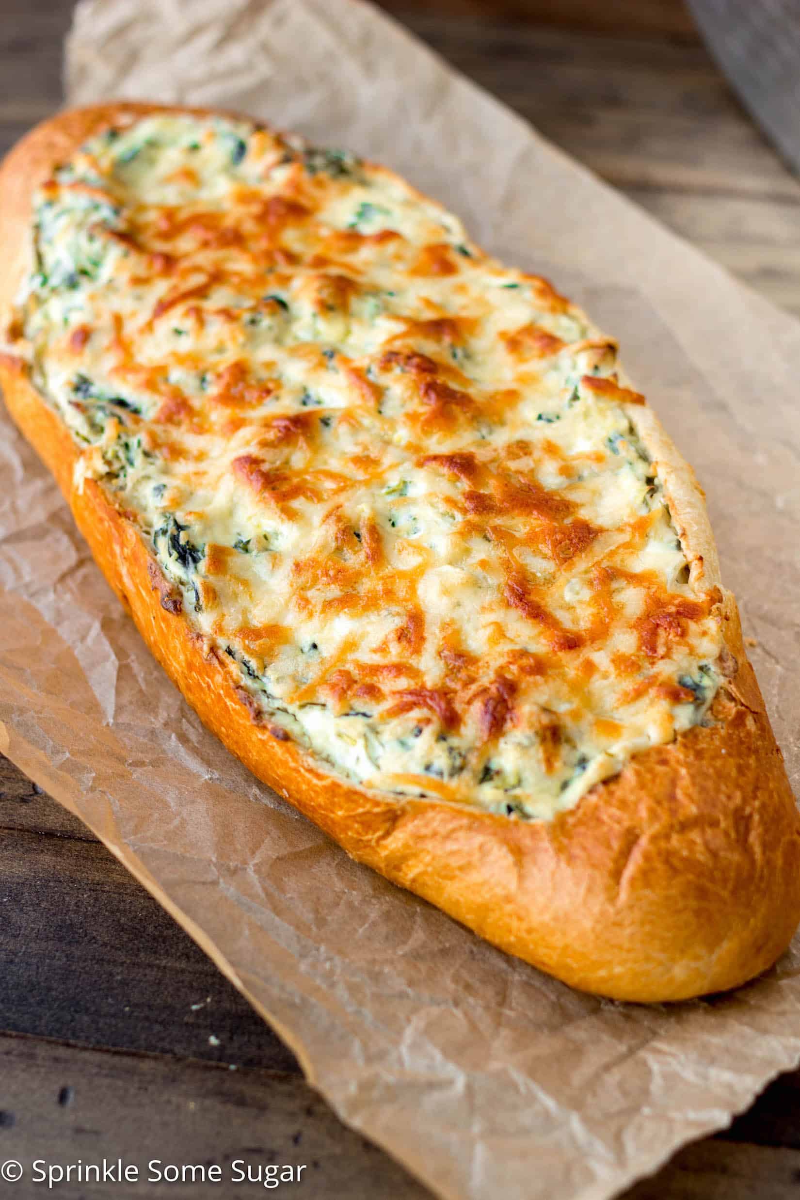 Crispy, crusty french bread gets filled with an extra creamy spinach and artichoke dip. - Spinach and Artichoke Stuffed Bread