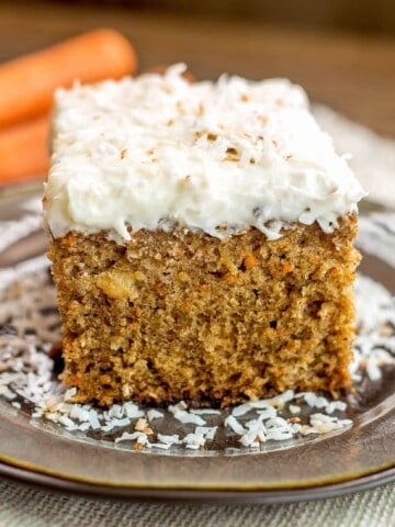 Pineapple Carrot Coconut Cake with Coconut Cream Cheese Frosting - This perfectly moist carrot cake is chock full of carrots, pineapple and coconut. Topped with hefty layer of my favorite coconut cream cheese frosting!
