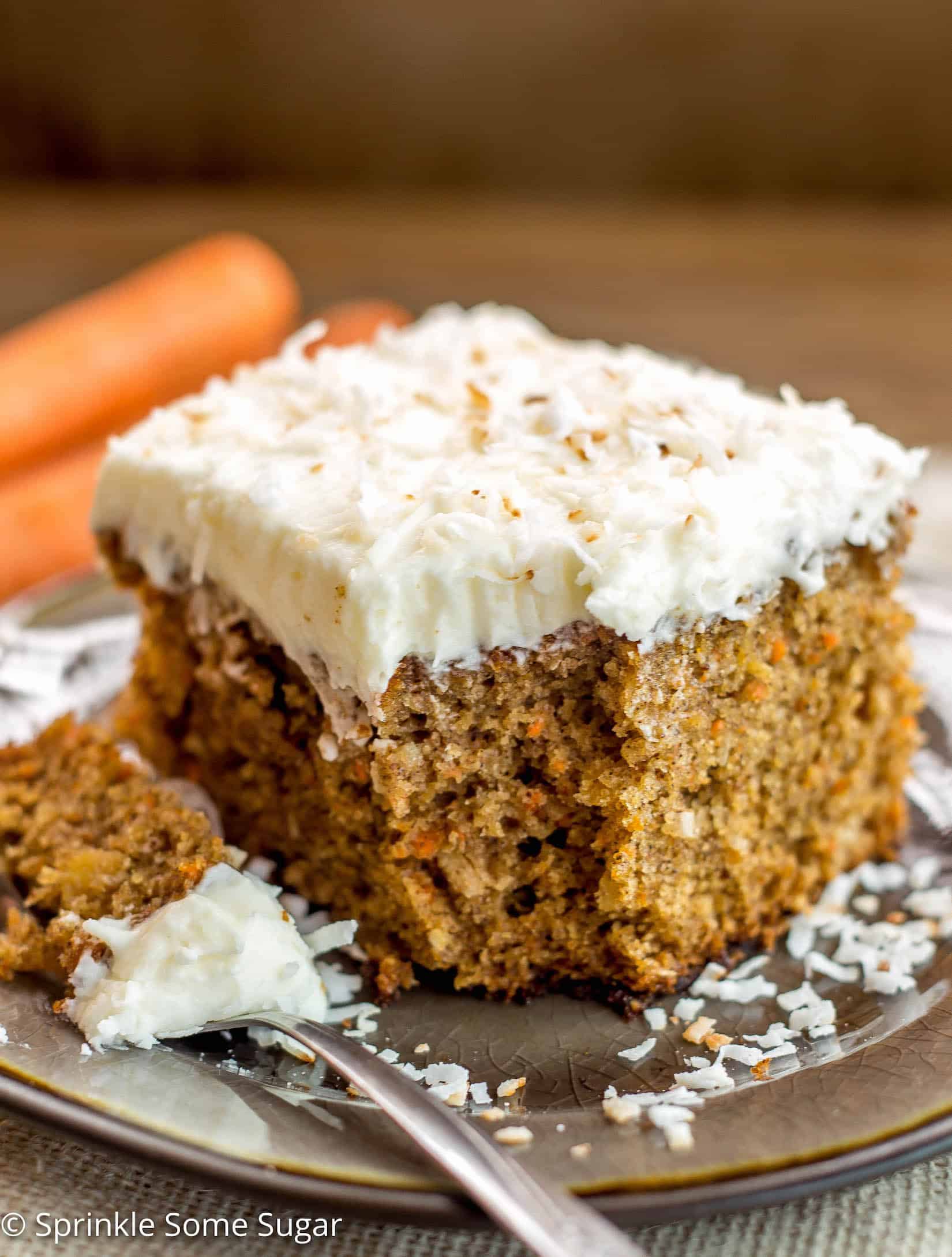 Pineapple Coconut Carrot Cake with Coconut Cream Cheese Frosting - This perfectly moist carrot cake is chock full of carrots, pineapple and coconut. Topped with hefty layer of my favorite coconut cream cheese frosting!