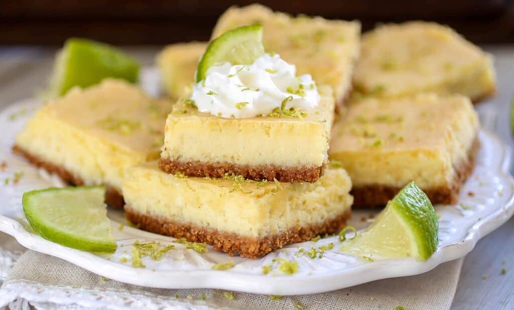 Key Lime Cheesecake Bars - Tart, tangy and sweet, these creamy Key Lime Cheesecake bars are sure to be a crowd pleaser!