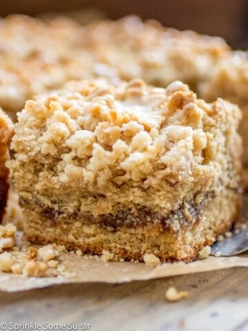 Cinnamon Swirl Coffee Cake - Soft lightly spiced coffee cake is filled with a gooey cinnamon swirl center and topped with a sweet streusel topping + vanilla glaze!