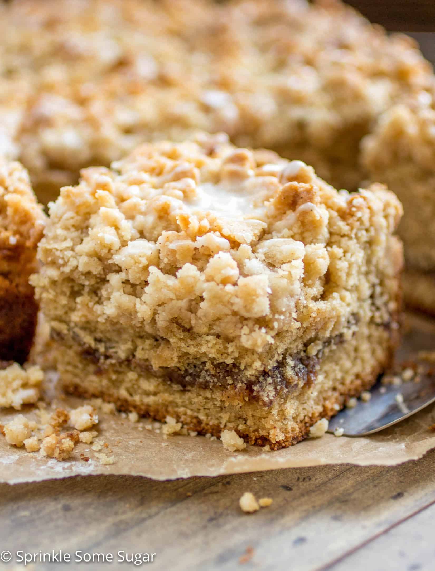 Slice of cinnamon swirl coffee cake with a spatula underneath.