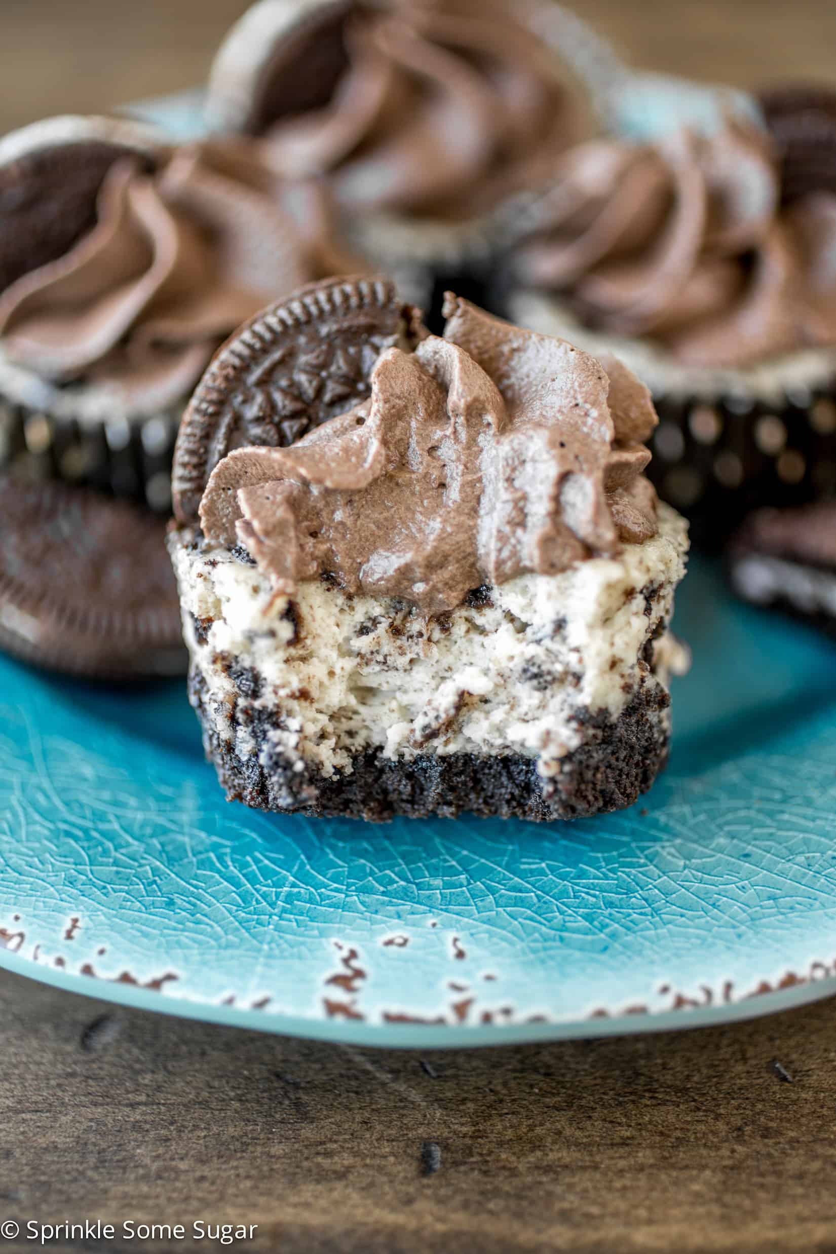 Mini Oreo Cheesecakes with Dark Chocolate Whipped Cream - These creamy mini Oreo cheesecakes with dark chocolate whipped cream are chock full of Oreos with an Oreo crust and topped with homemade whipped cream!