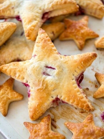 Cherries and Cream Cheese Danish Stars - These cherries and cream danishes are so much fun for the Summer holidays coming up! The dough is flakey, buttery, and crispy on the outside and the inside has a creamy cream cheese filling topped with some homemade cherry preserves!