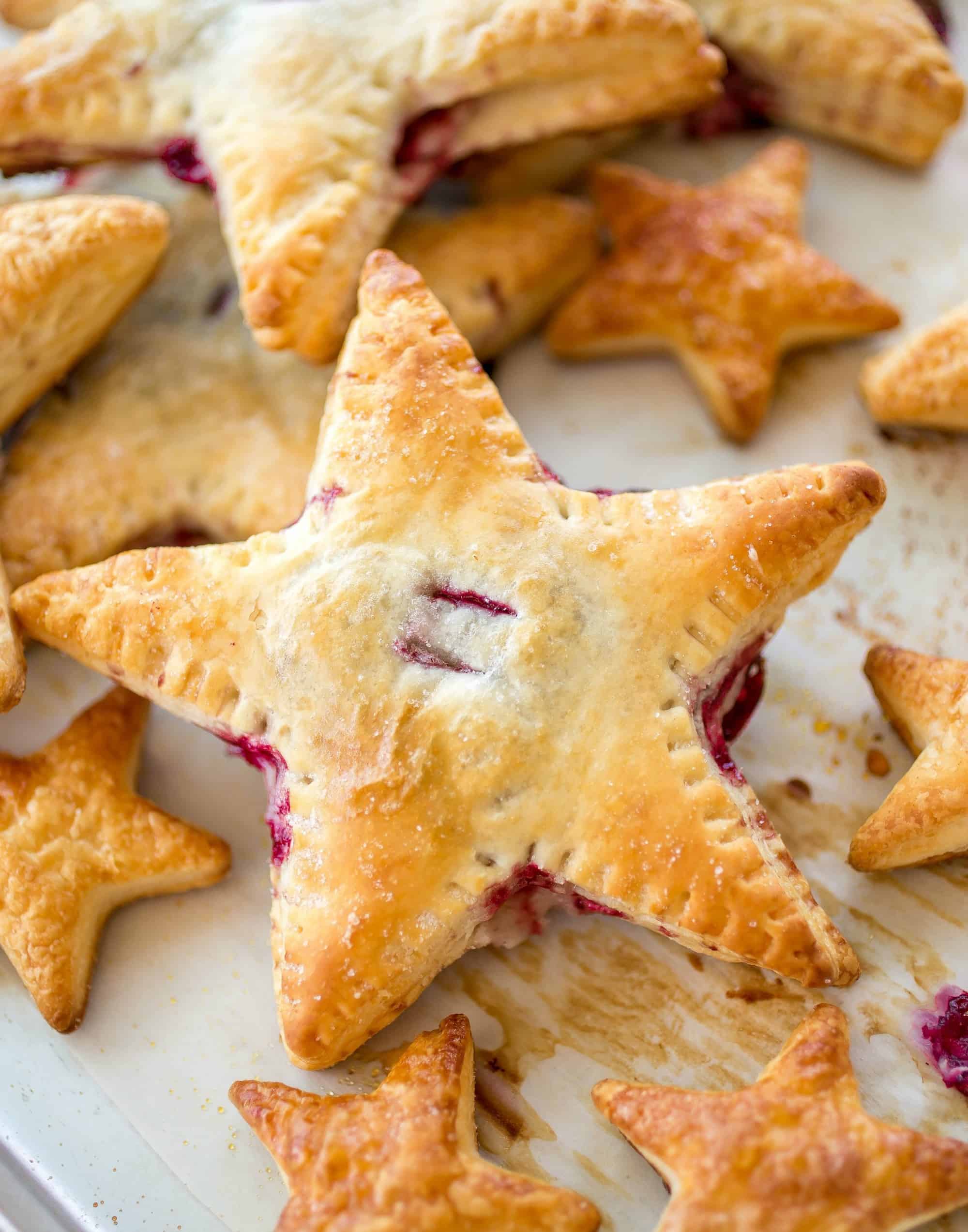 Cherries and Cream Danish Stars - These cherries and cream danishes are so much fun for the Summer holidays coming up! The dough is flakey, buttery, and crispy on the outside and the inside has a creamy cream cheese filling topped with some homemade cherry preserves!