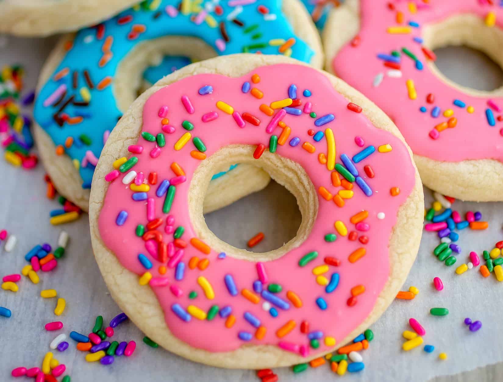 Donut Shaped Sugar Cookies with Royal Icing - Deliciously thick and soft sugar cookies decorated as donuts! These cookies will melt in your mouth!